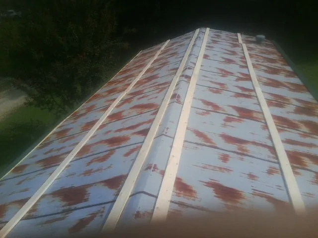 Rusted metal roof panels with new wood purlins before replacement — Storm Damage Roof Repair in Johns Island by Roofing Brothers